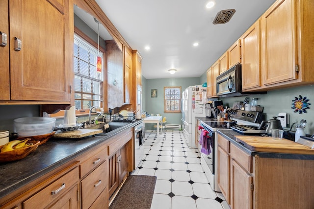 kitchen featuring white appliances, plenty of natural light, and sink