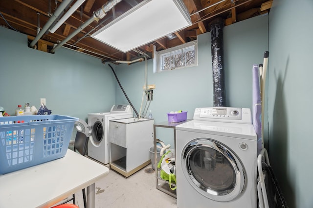 clothes washing area with washer and dryer and sink