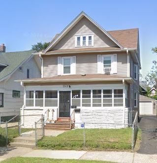 view of front of home with a garage and an outdoor structure