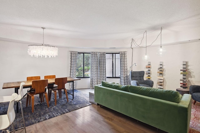 living room featuring dark wood-type flooring and a textured ceiling