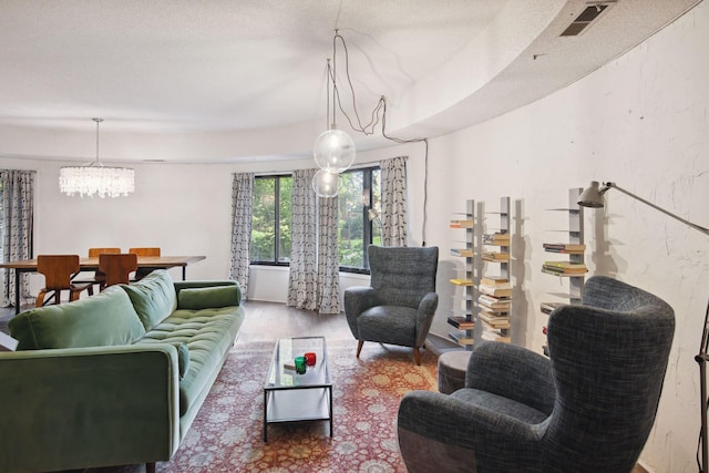 living room featuring wood-type flooring and a notable chandelier