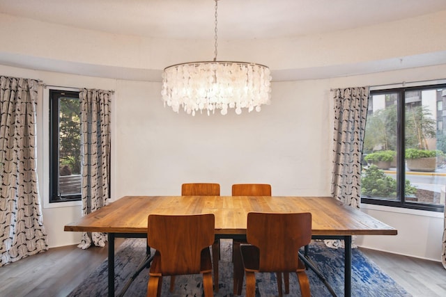 dining space featuring dark hardwood / wood-style floors, a chandelier, and a wealth of natural light