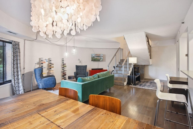 dining room with dark wood-type flooring and a fireplace