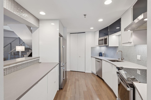 kitchen with white cabinetry, sink, and appliances with stainless steel finishes