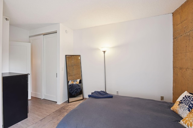 bedroom with a closet and light hardwood / wood-style flooring