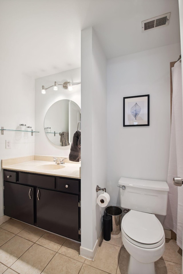 bathroom featuring vanity, tile patterned flooring, and toilet