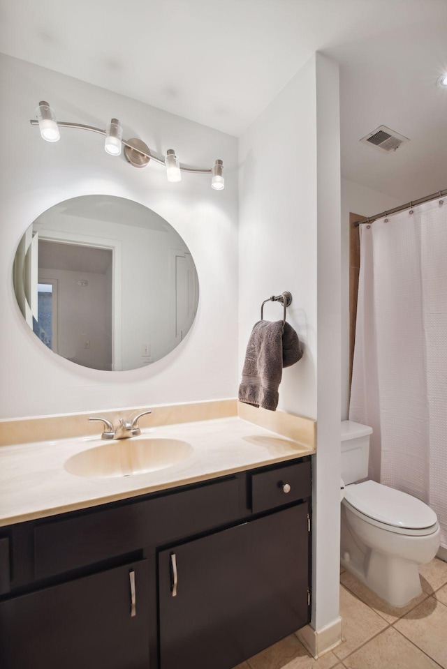 bathroom featuring vanity, toilet, and tile patterned flooring