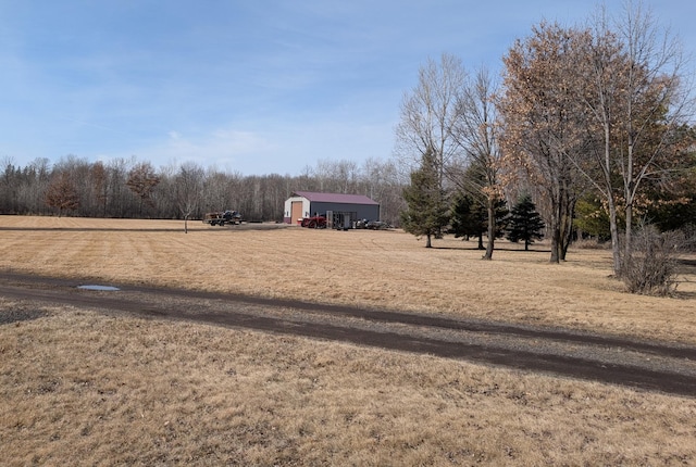 view of yard featuring an outbuilding and a rural view