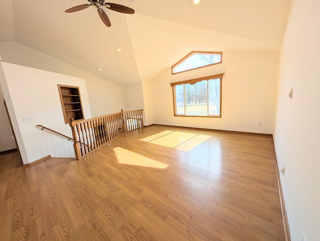 bonus room featuring built in features, wood finished floors, baseboards, lofted ceiling, and recessed lighting