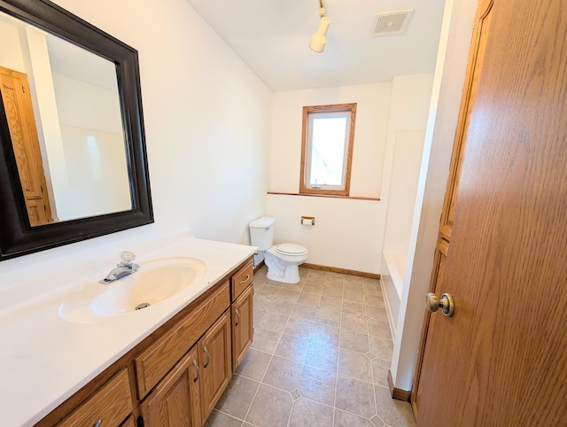 bathroom with visible vents, a tub, baseboards, toilet, and vanity