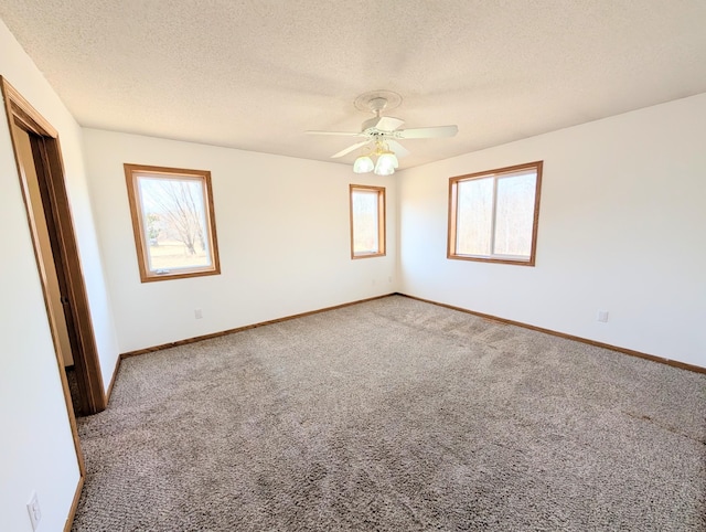 unfurnished bedroom with ceiling fan, baseboards, carpet floors, and a textured ceiling