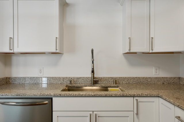 kitchen with dishwasher, sink, white cabinets, and light stone counters