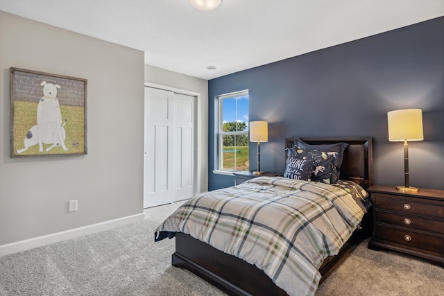 bedroom featuring light carpet and a closet