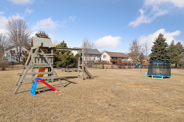 view of jungle gym featuring a trampoline, fence, and a yard