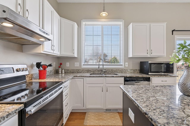 kitchen with under cabinet range hood, white cabinets, stainless steel appliances, and a sink