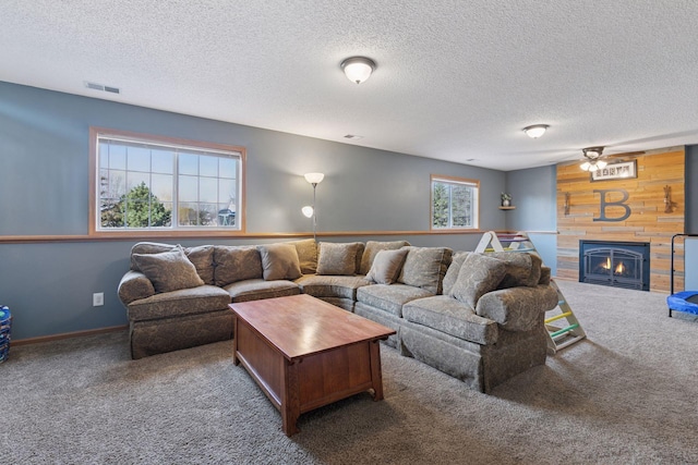 living room with visible vents, a large fireplace, carpet, and a textured ceiling