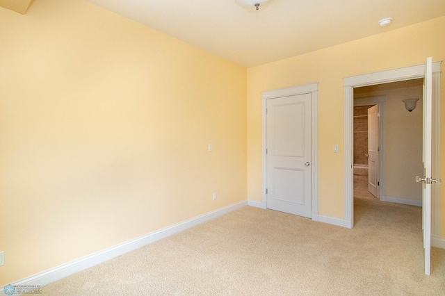 unfurnished bedroom featuring light carpet