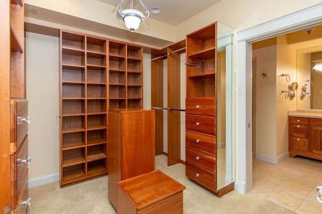 walk in closet featuring light carpet