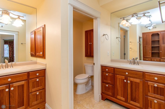 bathroom featuring vanity, tile patterned floors, and toilet