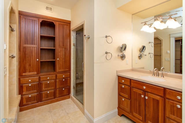 bathroom featuring vanity, tile patterned floors, and a shower with shower door