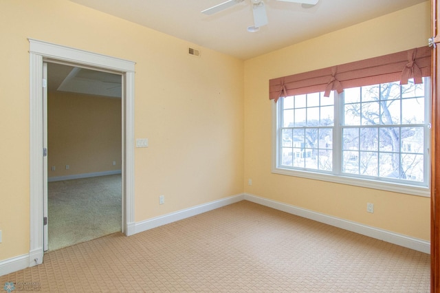 spare room featuring ceiling fan and light colored carpet