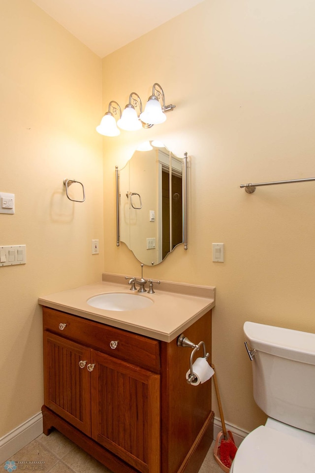 bathroom featuring vanity, toilet, and tile patterned flooring