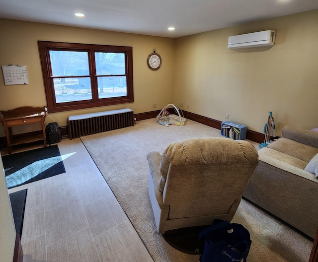 interior space featuring baseboards, recessed lighting, a wall unit AC, and radiator