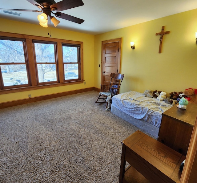 bedroom with carpet floors, a ceiling fan, visible vents, and baseboards