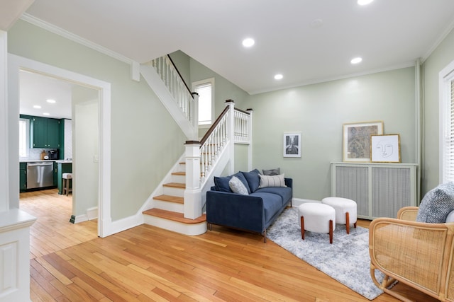 living room with light hardwood / wood-style flooring and ornamental molding