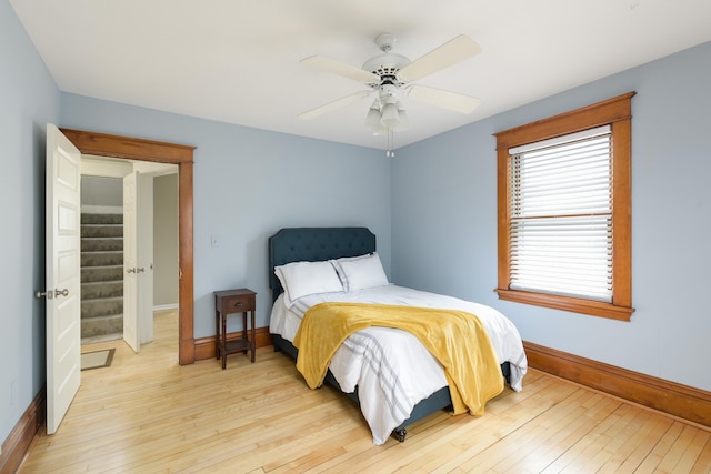 bedroom with ceiling fan and light hardwood / wood-style flooring