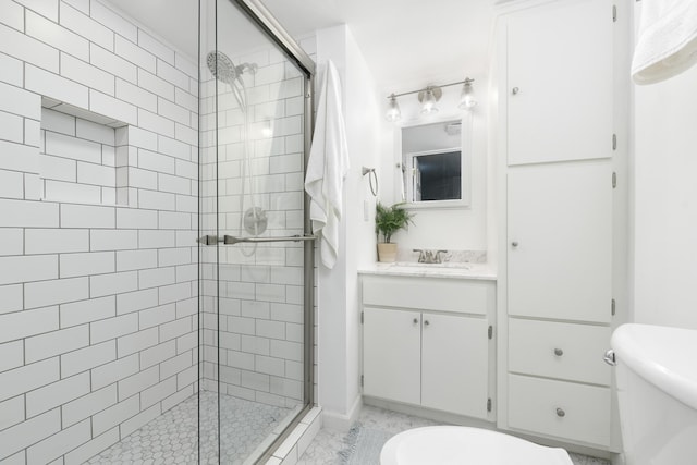 bathroom with walk in shower, vanity, and toilet