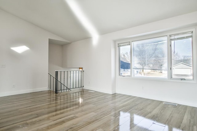 bonus room featuring hardwood / wood-style flooring and lofted ceiling