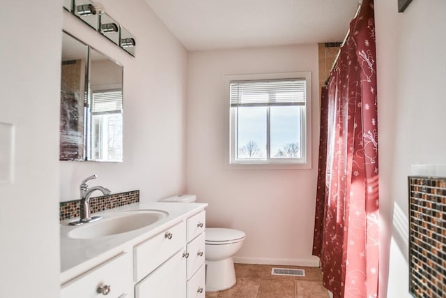 bathroom featuring walk in shower, tile patterned floors, vanity, and toilet