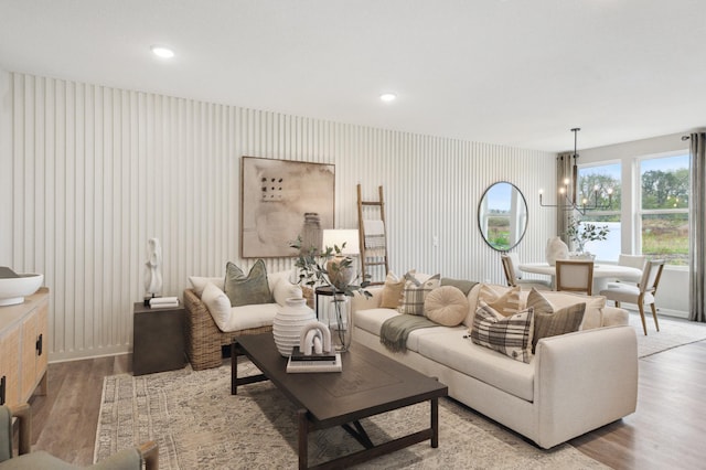 living room with a notable chandelier and hardwood / wood-style flooring