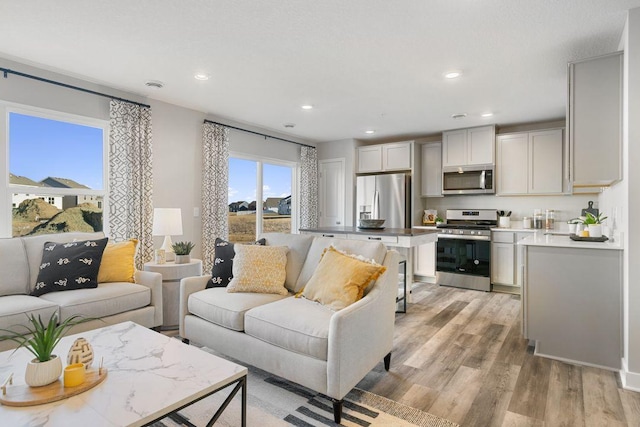 living room with recessed lighting and light wood-type flooring