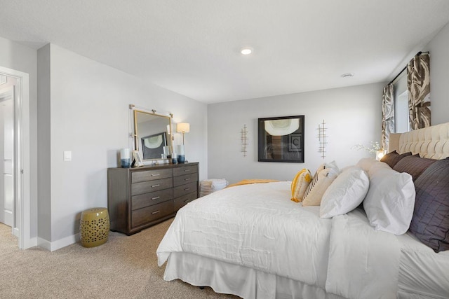 bedroom with recessed lighting, baseboards, and light carpet