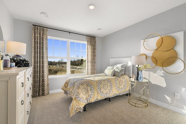 carpeted bedroom featuring baseboards