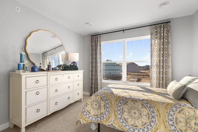 bedroom featuring baseboards and light carpet