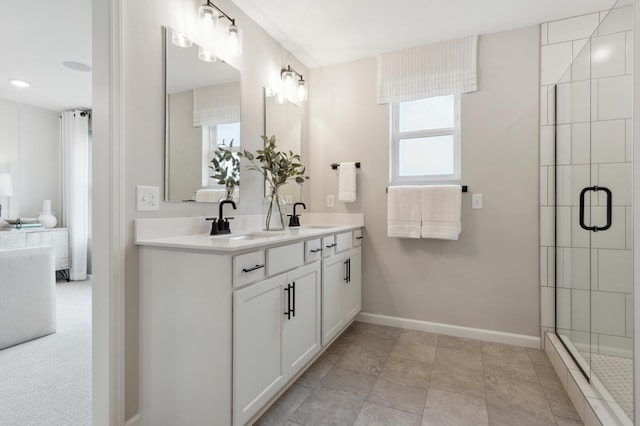 bathroom featuring vanity and a shower with door