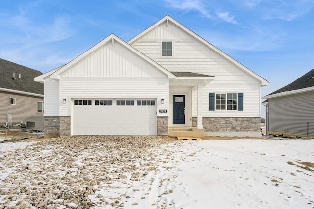 view of front facade featuring central AC unit and a garage