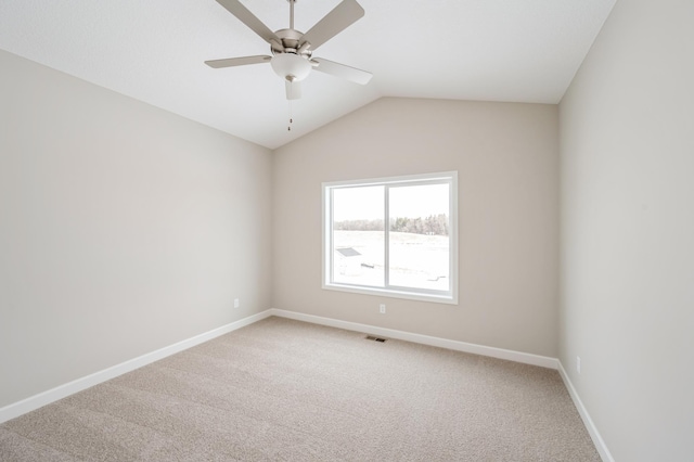 carpeted spare room with lofted ceiling and ceiling fan