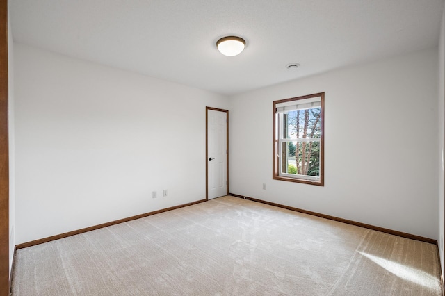 empty room featuring light colored carpet