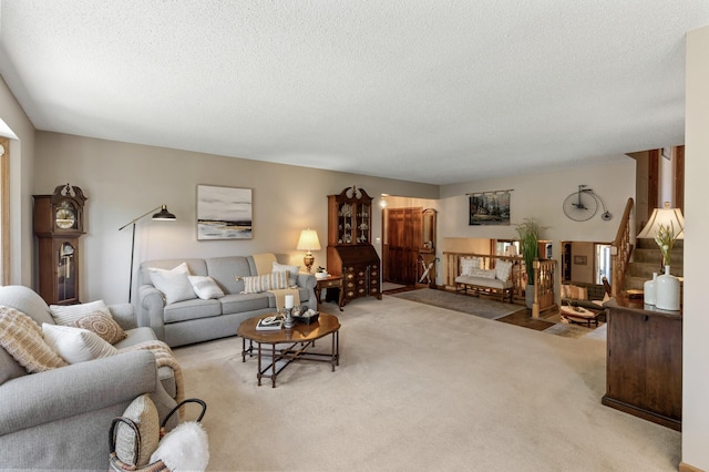 living room featuring light carpet and a textured ceiling