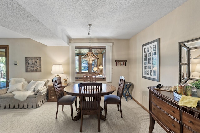 carpeted dining space with a textured ceiling