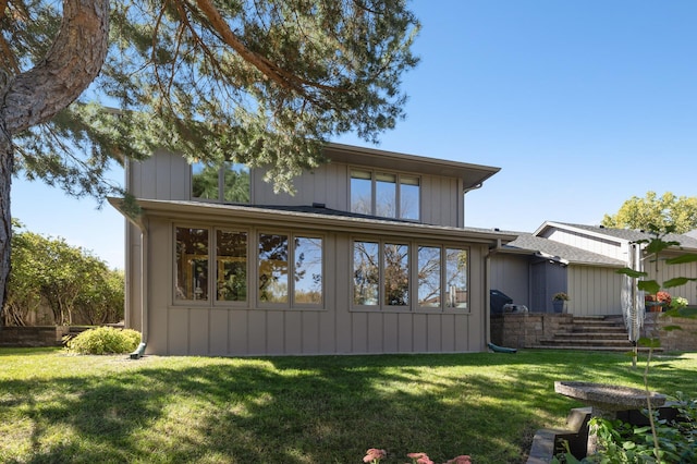 back of house with a lawn