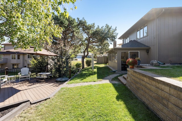 view of yard featuring a sunroom and a deck