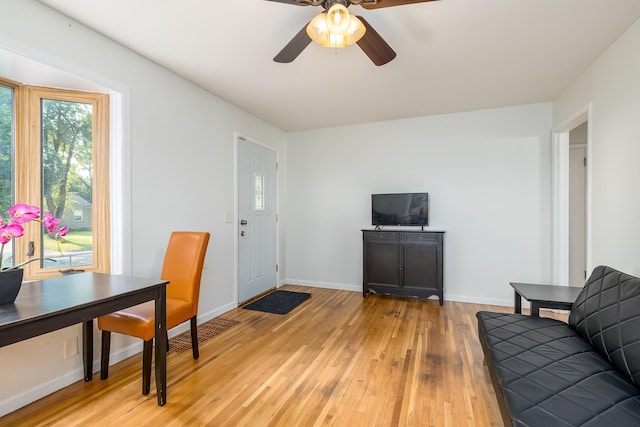 living room with ceiling fan and light wood-type flooring