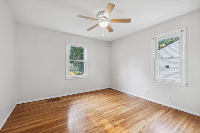 unfurnished room with hardwood / wood-style floors and ceiling fan