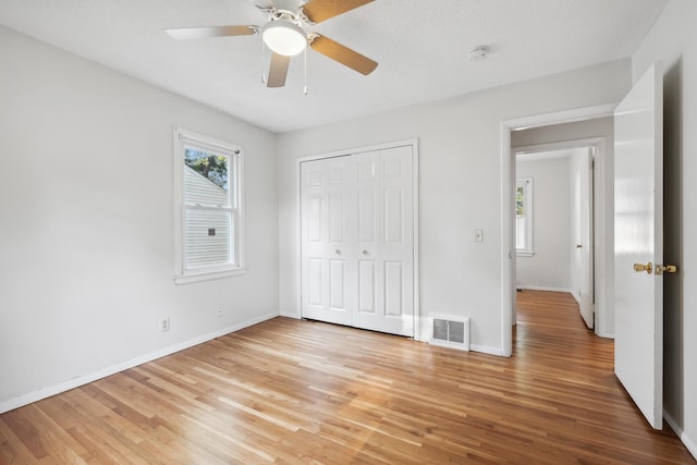 unfurnished bedroom with a closet, ceiling fan, and light hardwood / wood-style flooring