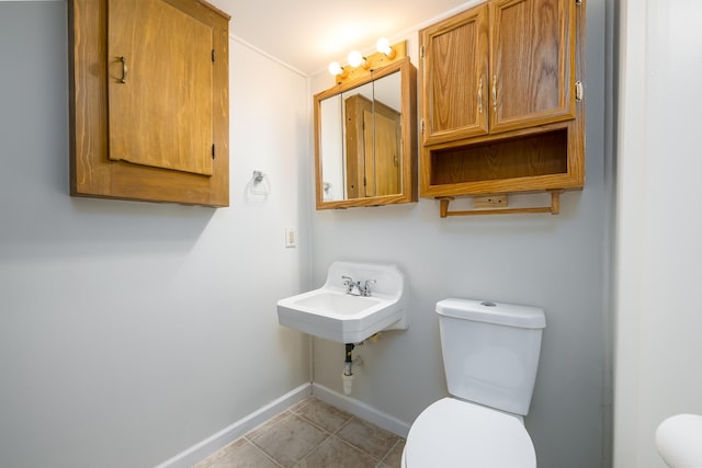 bathroom with sink, tile patterned floors, and toilet